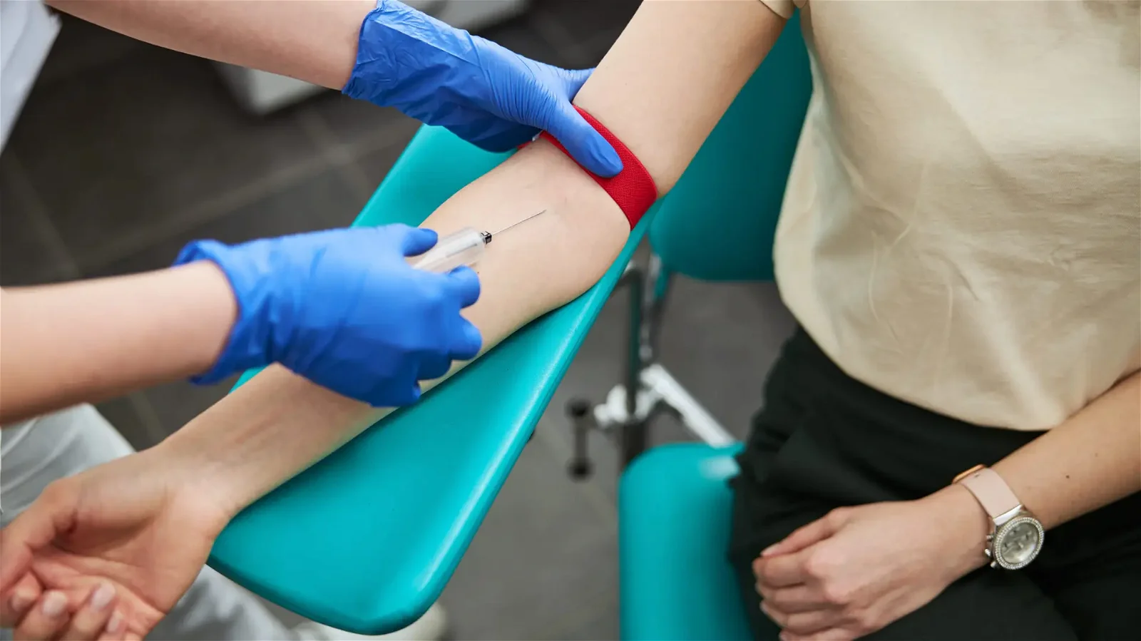 Inserting needle into arm vein. IV Sedation in dental chair.